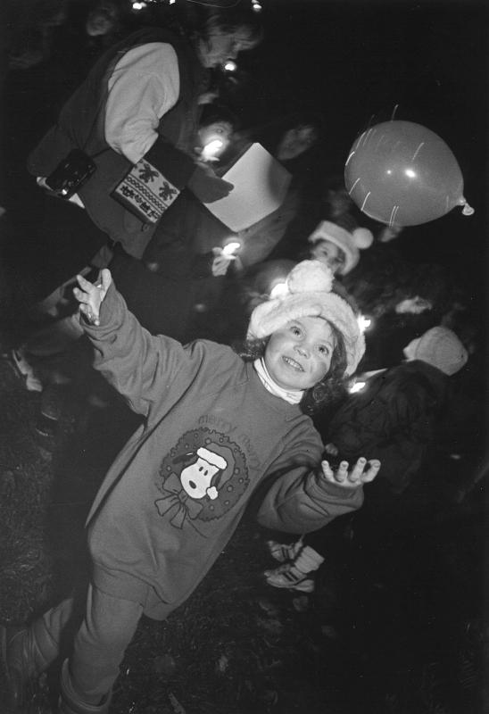 Julie Sing, 4, of Lewes plays at the Lewes tree-lighting and caroling event.