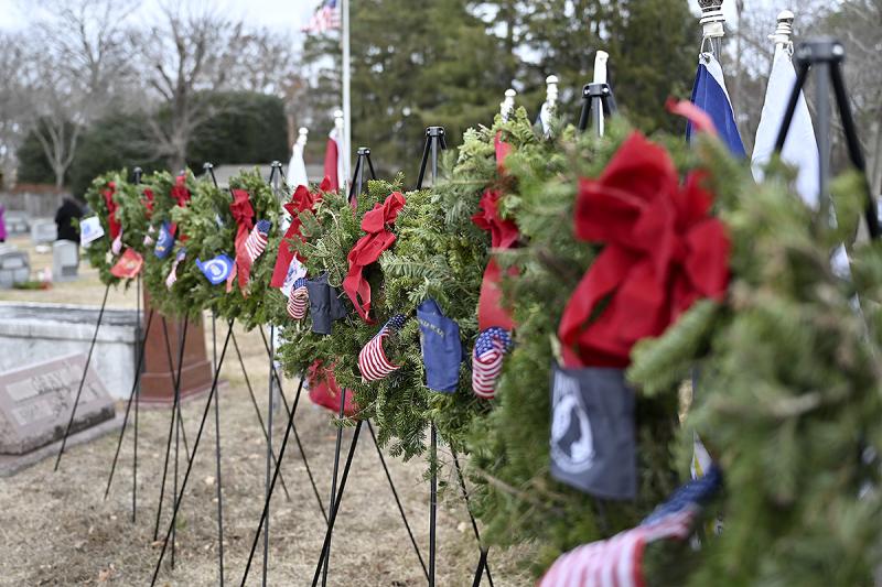Ceremonial wreaths representing the Army, Marines, Navy, Air Force, Space Force, Coast Guard, Merchant Marines and POW-MIA are lined up for the ceremony.
