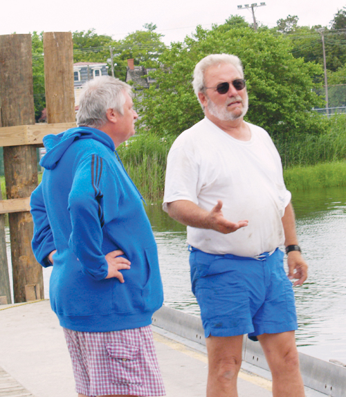 After his boat is high and dry at Anglers Marina, owner Keith Moffat, left, talks with marina owner Jay B. Walsh about painting the few minor scrapes on the boat’s keel.