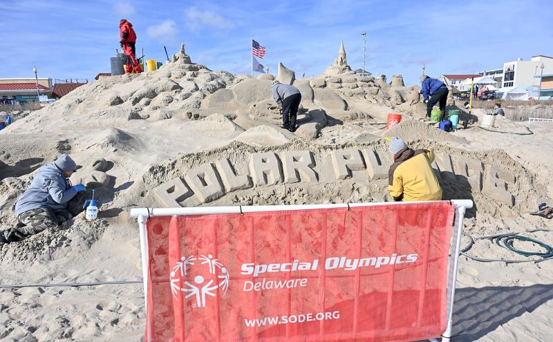 Pete the Sand Man and his workers put the finishing touches on their sandcastle for the event.
