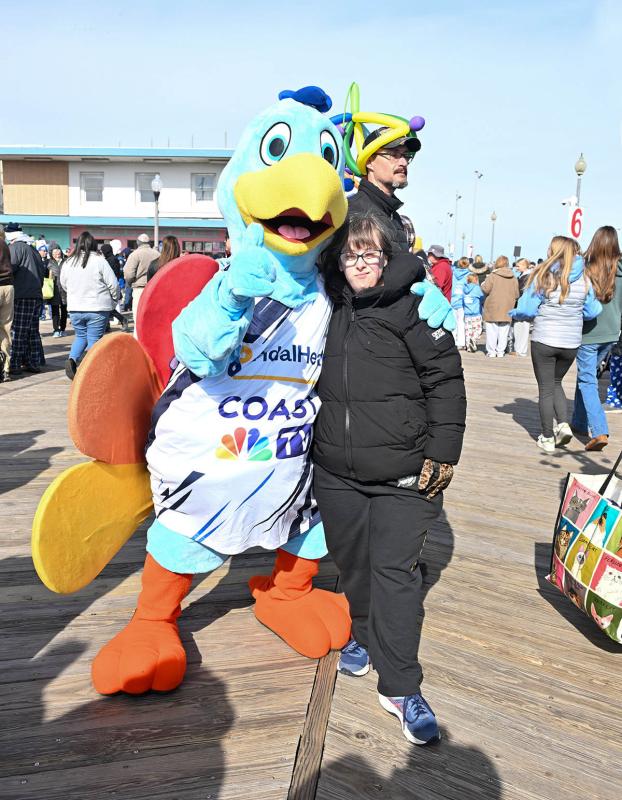 Jamie Stephens of Georgetown poses with the Coast TV Peacock Petey.