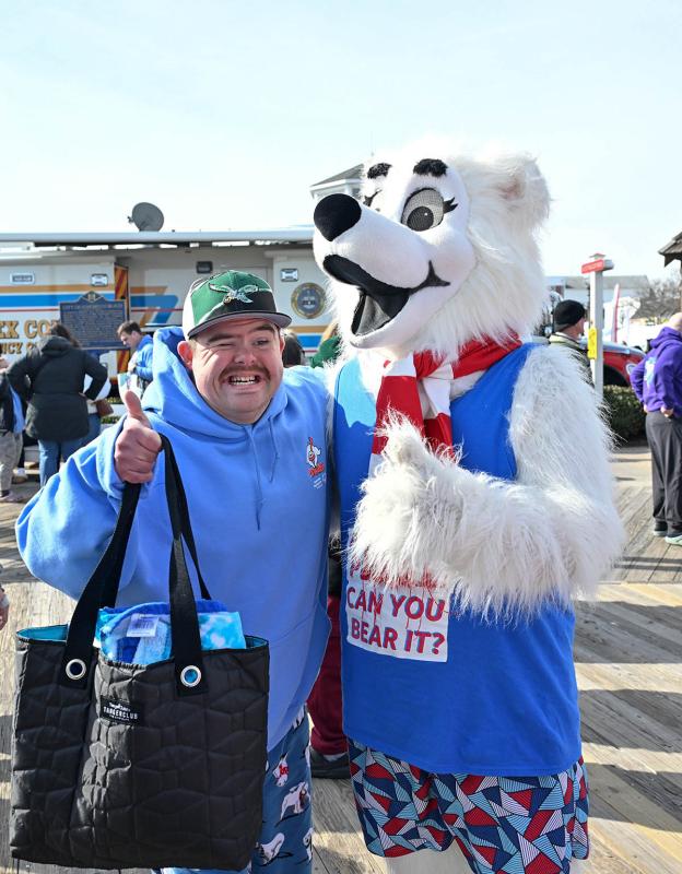 Special Olympics athlete Connor Watson poses with Lewie P. Bear.