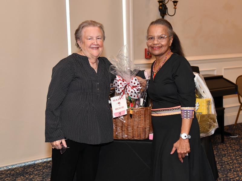 Patricia Higginbotham, right, presents a basket to winner Ellen Hammond.