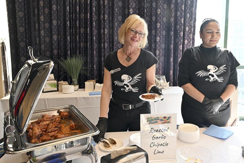 Suzanne Gustafson and Sylvia Cosme serve wings from Kiwi’s Cove.