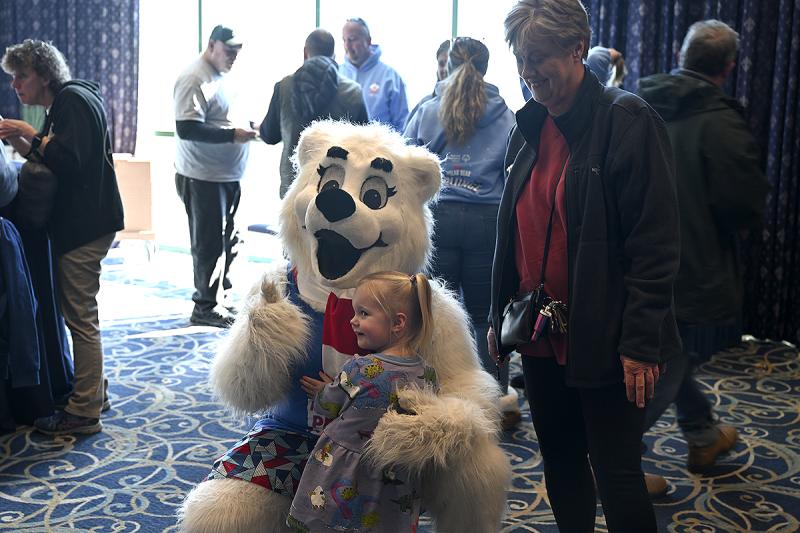 Caroline McClelland hugs Lewie P. Bear as grandmother Maureen McClelland looks on.