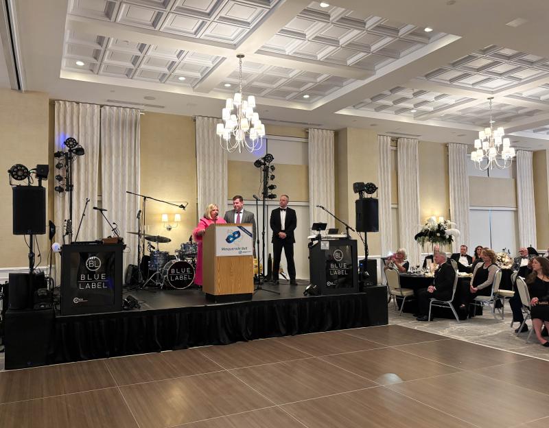 Vanessa and Matt Megee, wife and son of the late Terry Megee, after whom the Terry Megee Great Futures Award was named, speak alongside John Wellons at the Boys & Girls Clubs’ 11th annual Masquerade Ball.