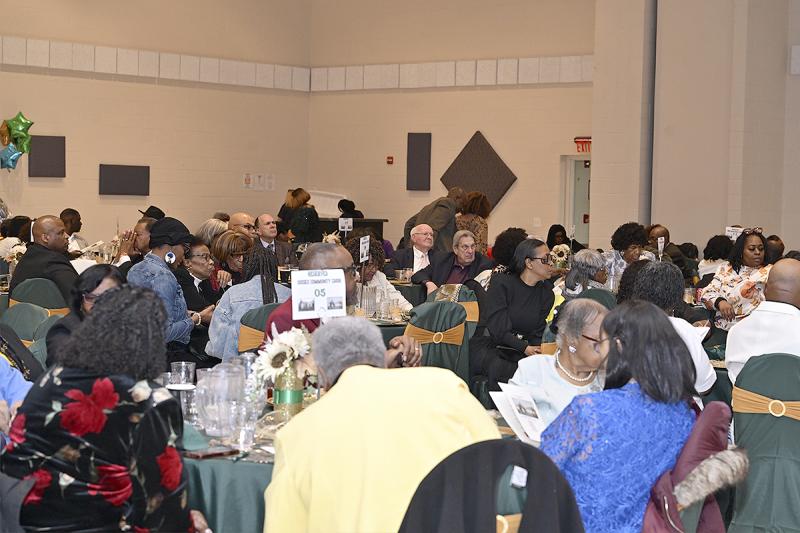 The crowd enjoys a meal and conversation.