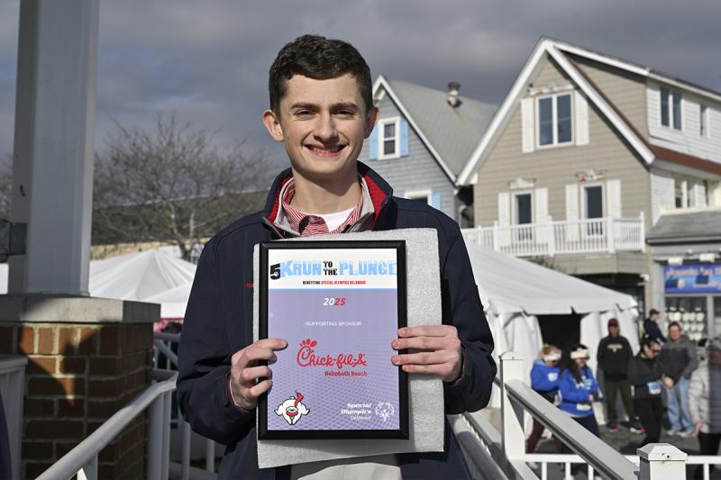 Aaron Mattis of Chick-fil-A accepts a plaque for sponsoring the event.