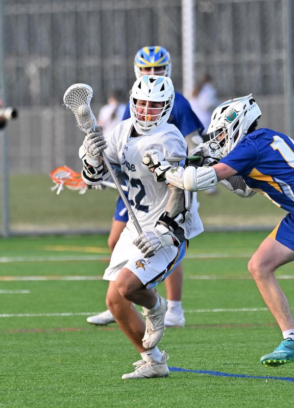 Cape senior Brycen Stewart power cradles around a Central long pole defender.