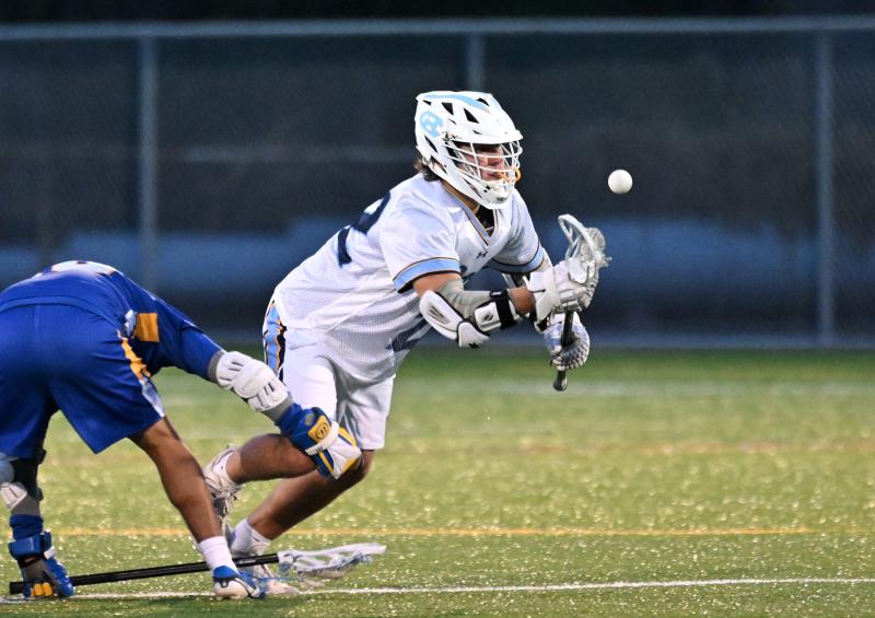 Cape senior middie Brycen Stewart wins a face-off in the fourth quarter.