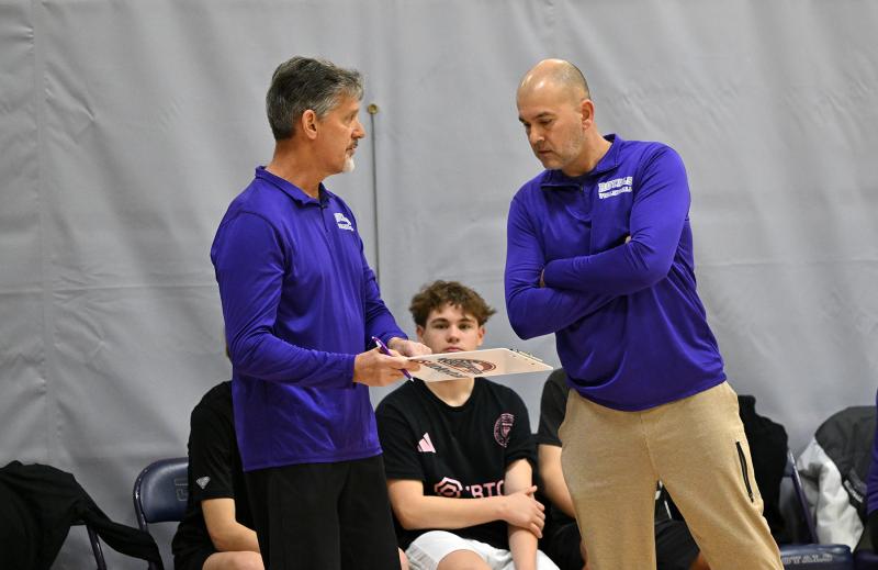 Royals head coach Jim Berger, right, talks over strategy with his assistant John Rahl. Missing from the picture is assistant Mike Gilbert.