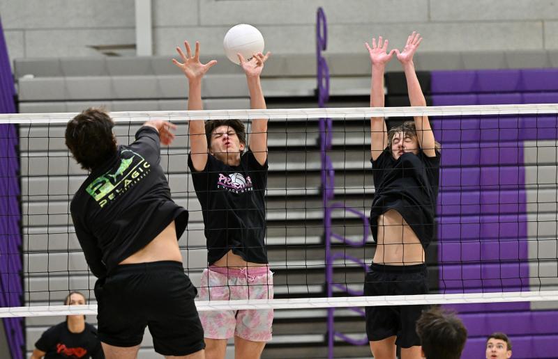 Royals front-line players Ethan Fels, center, and Henry Ennis go for a block at the net.