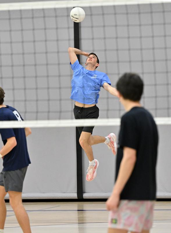 Cape senior Kieran Morrissey gets major air for a service ace.