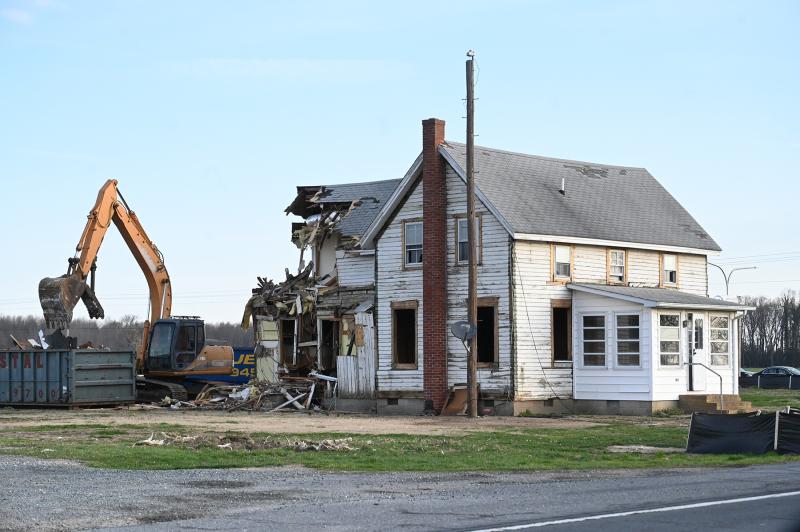 The century-old home at the corner of Cave Neck Road and Route 1 is demolished March 28. NICK ROTH PHOTOS