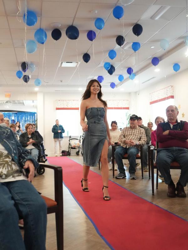 Ryleigh Moyer, a junior, models a denim strapless dress that she designed, inspired by fashion designer Stella McCartney.