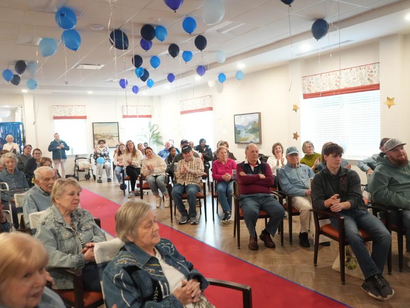 Friends and residents at the Lodge watch the fashion show.