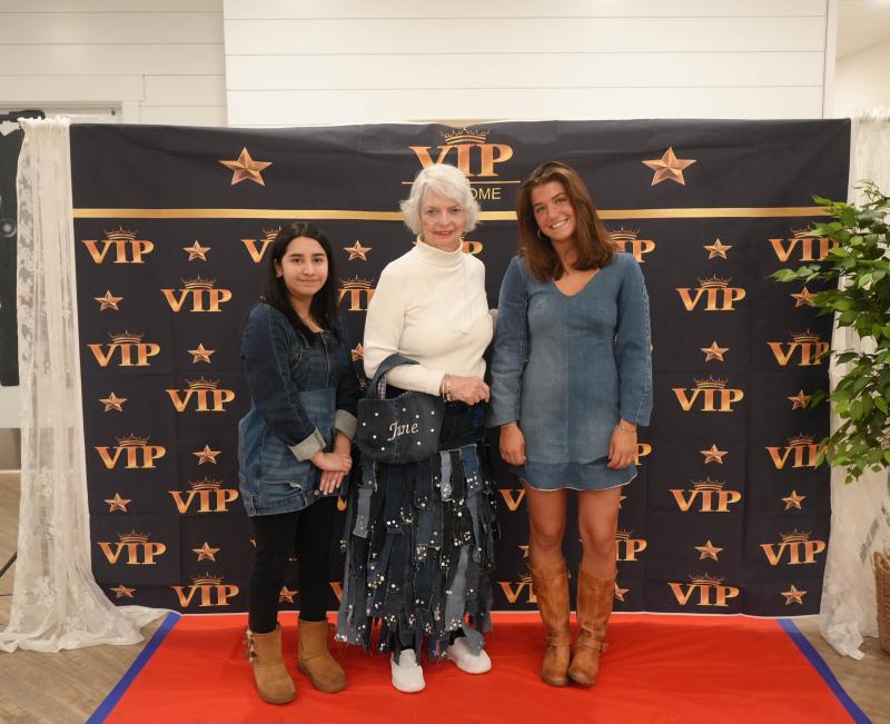 Students Alexa Ayella, left, and Milena Buehler stand with June Walters, who’s modeling garments that they designed for her. Buehler designed the skirt, and Ayella designed the purse.
