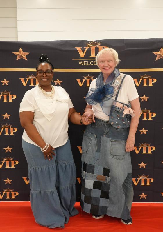 Reshell Truitt, left, director of programming at the Lodge at Historic Lewes, stands with Lodge resident Helen Janson, who’s wearing a skirt designed by student Alexandria Espinoza and a purse designed by student Brianna Holston.