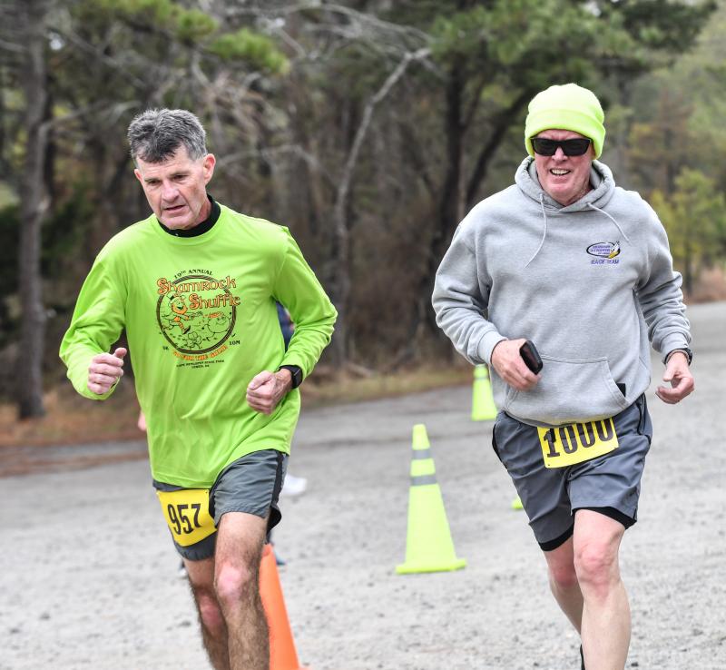 Allen Quillen and Richard Tikiob cross the finish line in 30:21.