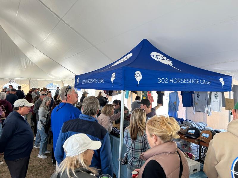 Customers line up at the 302 Horseshoe Crab merch tent.