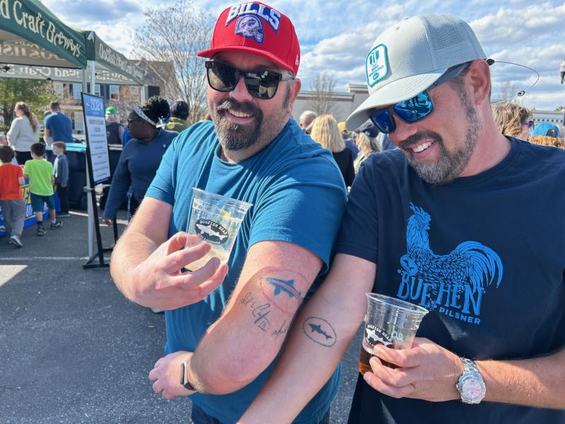 Among the beer enthusiasts who came out for 302 Day are Zach Dick, left, and Jason King, who show off their Dogfish Head tattoos. RYAN MAVITY PHOTOS