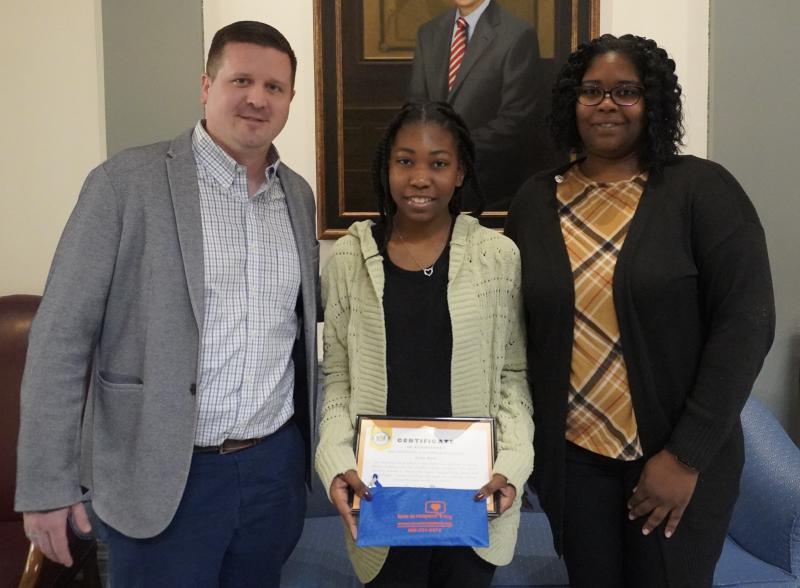 Sussex Academy eighth-grader Zylah Nash was recognized by the Delaware Domestic Violence Coordinating Council for her winning poster contest entry. Gathered at the ceremony are (l-r) Head of School Kyle Bentley, Zylah and her mother, Chavai Nash. SUBMITTED PHOTO