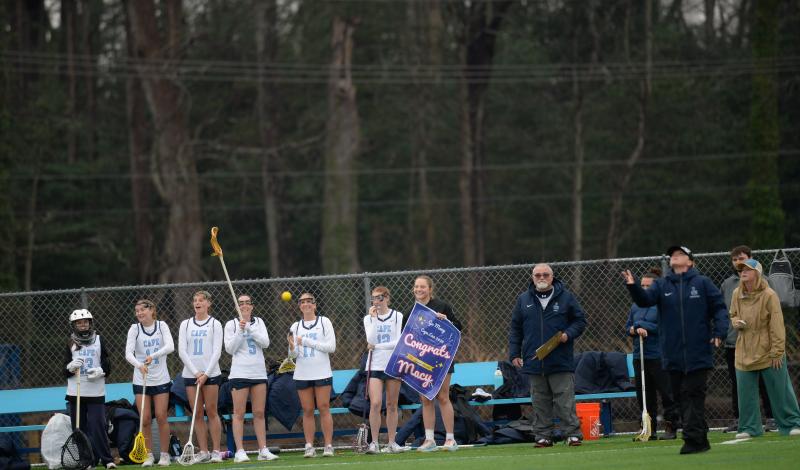 Captain Lina Frederick waits to present captain Macy Steinwedel with her banner.