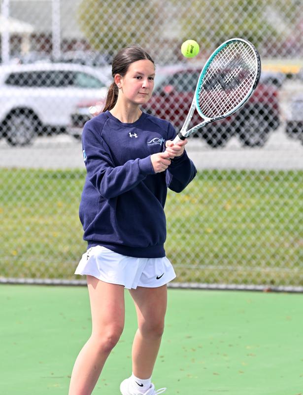 Cape’s Kortney Kosc hits a high backhand drive at first doubles.