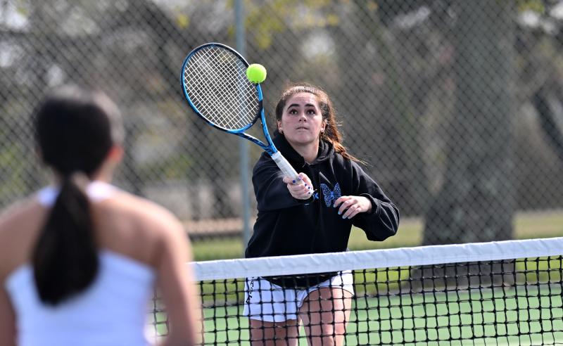 Cape first-doubles player Mya DiSabatino pops a forehand volley.