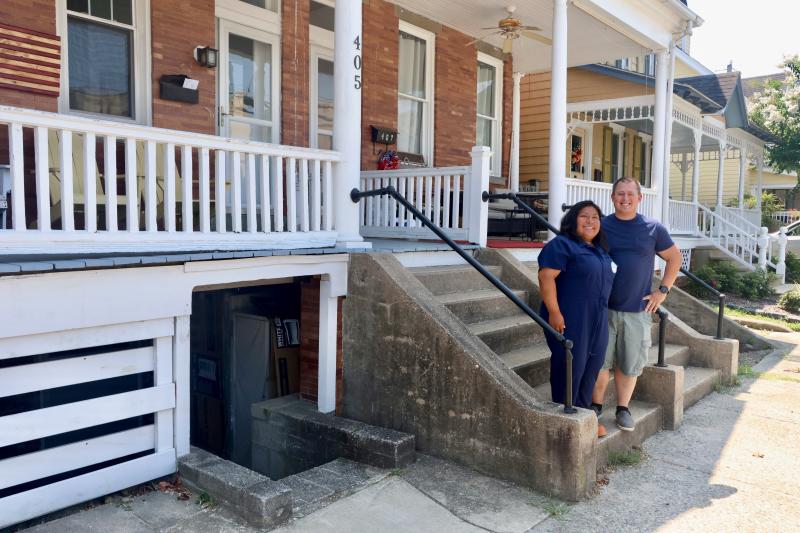 Sarah Prieto, left, and Stephen Matthews in front of their row home at 405 Savannah Road last summer. The couple is trying to win approval from the city to open a dog grooming business in their basement. BILL SHULL PHOTO