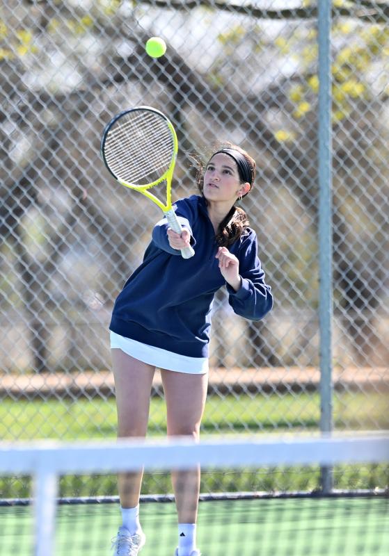 Sussex Academy’s Gia Berberian serves at first doubles.