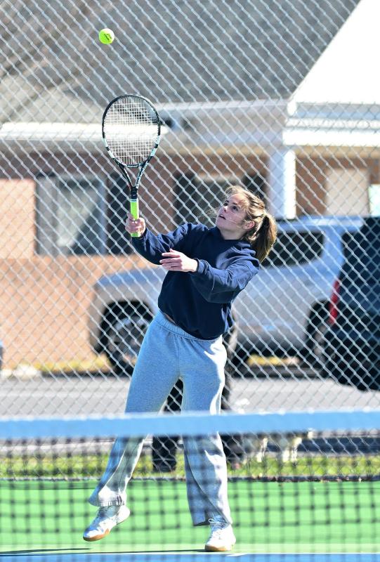 Julia DiSabatino hits a serve at third singles.