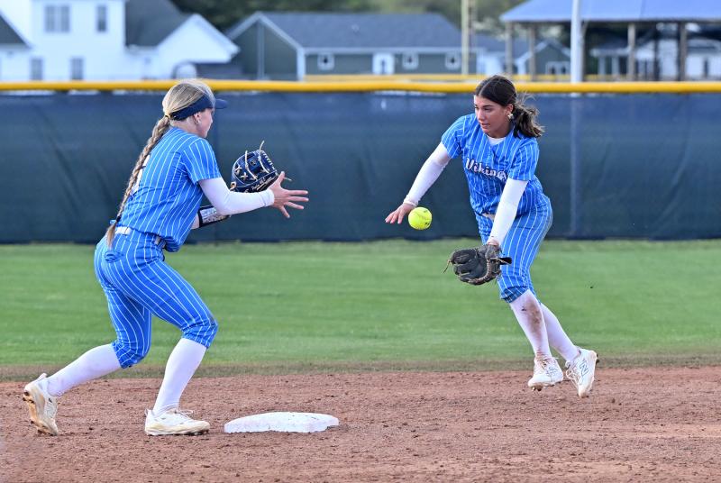Senior second baseman Milena Buehler, right, flips to Ava Calciano to start the first half of a double play.