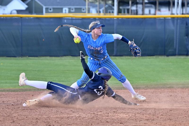 Cape shortstop Ava Calciano tags second and throws to first to finish a double play.