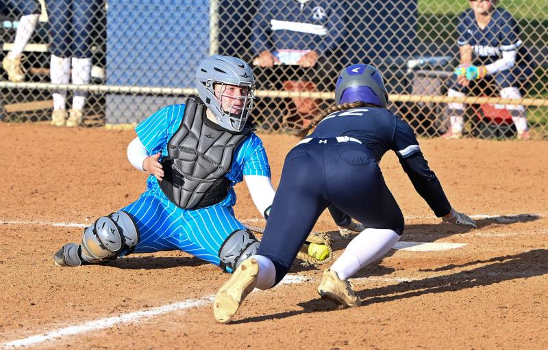 Cape senior catcher Alivia Heers puts the tag on a diving Caroline White for the second out of a double play in the seventh inning.