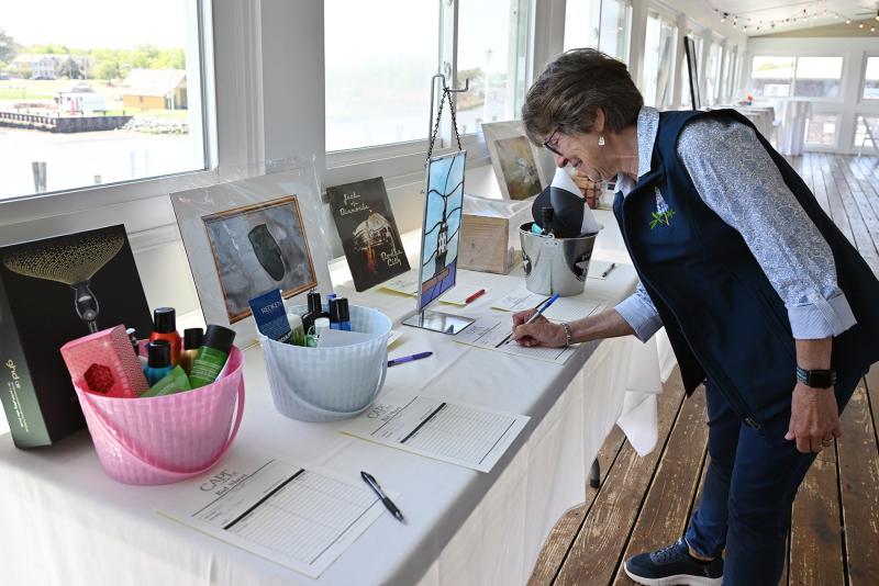 Kathy House gets an early start on bidding at the silent auction.