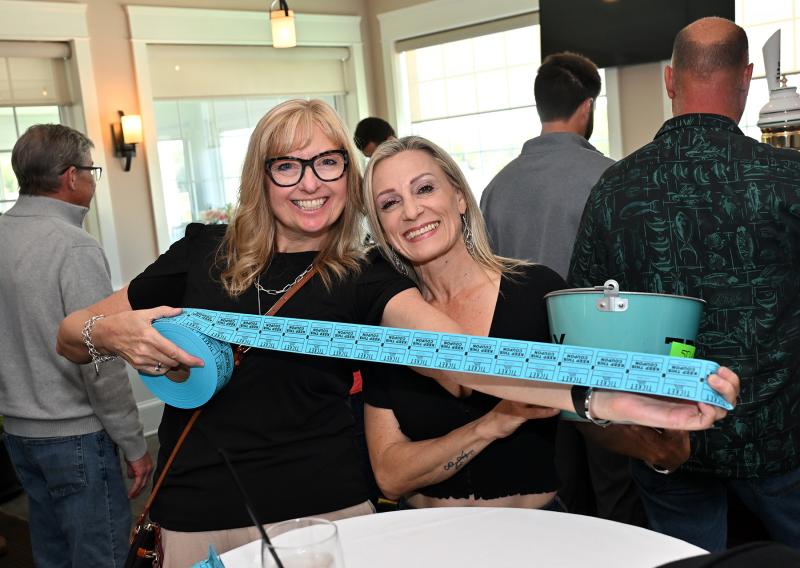 Volunteers Mary Lawson, left, and Shondelle Graulich sell 50/50 tickets during the event.