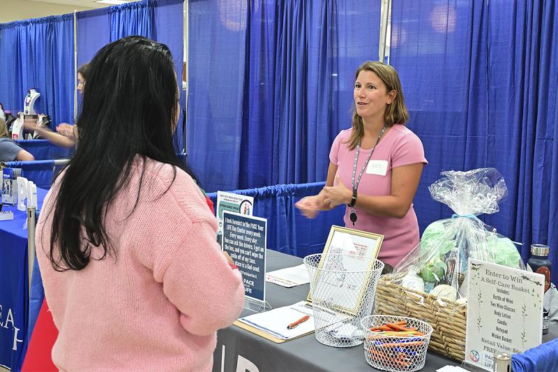 Tien Jinh, left, speaks with Lindsey Smyser, community engagement coordinator for Pace Your Life.