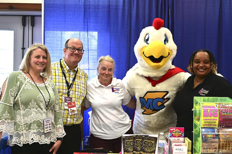 Posing for a photo are (l-r) Meghan Bayline and Brian Chase with Forever Media, Lea Perneski with the Delaware Lottery, The Mighty Chicken with WCHK 101.3 and Patricia Lewis with the Delaware Lottery.