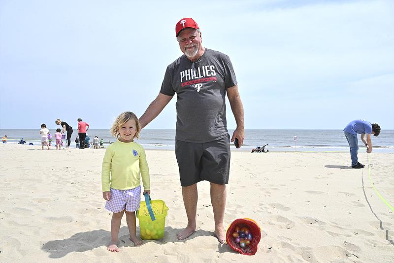 Charlie Lasater, age 3, and Lou Pagnoni soak up the rays and collect some eggs.