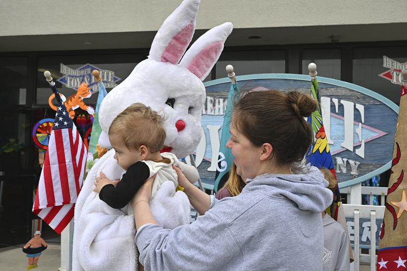 Benjamin Mitchell checks out the Easter Bunny with his mother Olivia Mitchell standing by.