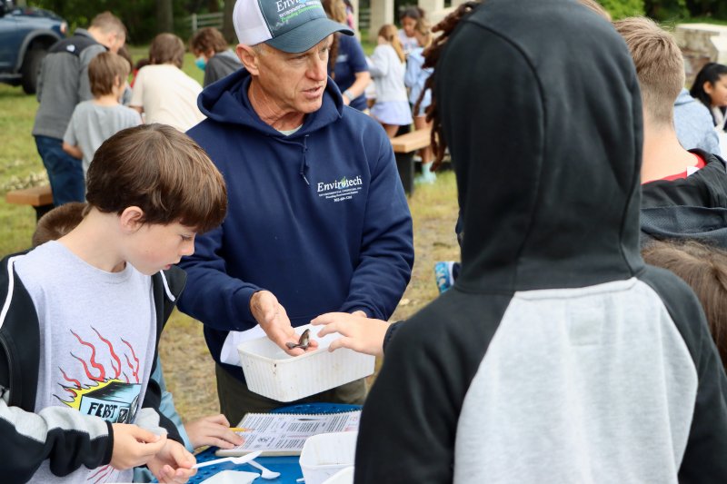 Blair Cherico, left, looks at a small catfish that Todd Fritchman is holding. Fritchman is an aquatic biologist and president of Envirotech Environmental Consultants. His presentation gave students a hands-on experience with the diverse ecology of the lake.