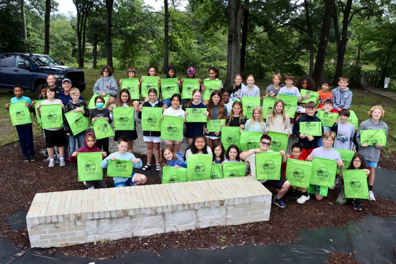 The fifth-graders who took part in the first workshop of the morning show off tote bags given out by the Save Our Lake Alliance 3. The bags were filled with educational material about our local lakes.