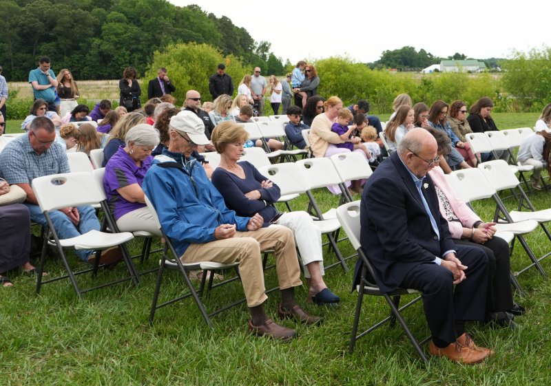 Community members and students, families, alumni and faculty from Delmarva Christian are led in prayer at the groundbreaking ceremony by Head of School Matt Kwiatkowski.