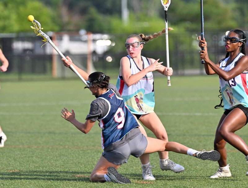 Blue team’s Hannah Zimmerman of Milford gets taken down by the White squad’s Isabella Sachetta of Appoquinimink.