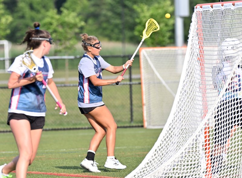 Sussex Academy’s Emiley Bisaha passes in front for an assist.