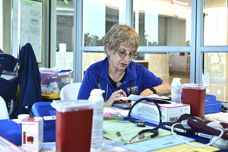 Mary Summerville, RN, gets her station set up for the event. TED PFIRRMANN PHOTO