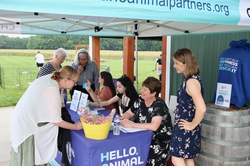HAP staff check people in for Wags, Whiskers and Wine at Honey Bee Barn near Milton.