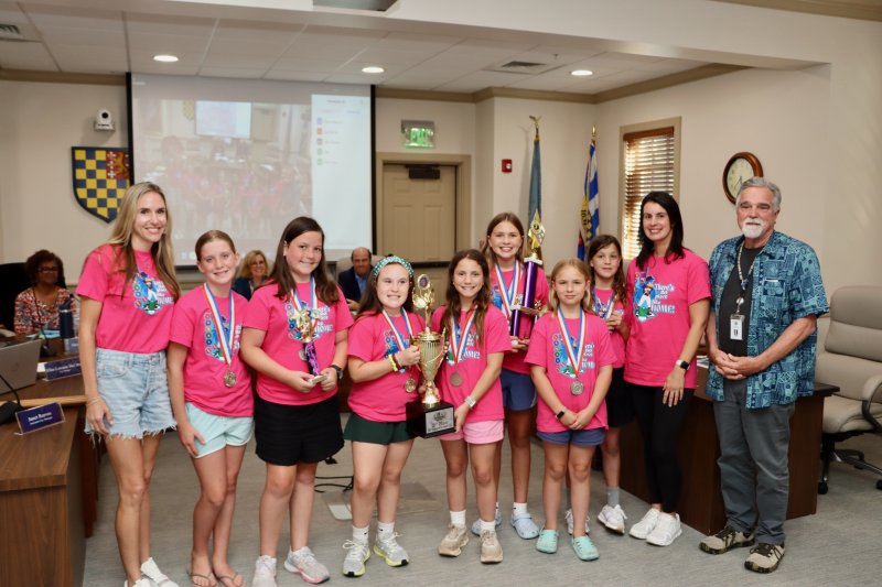 Team members, coaches and city officials gathered June 9. Shown are (l-r) coach Lauren James, Olivia Catts, Ellie Beck, Maisie MacGowan, Lucille Elder, Claire James, Quinn Callahan, Molly Ryan, coach Nicole Ryan and Councilman Joe Elder. BILL SHULL PHOTO