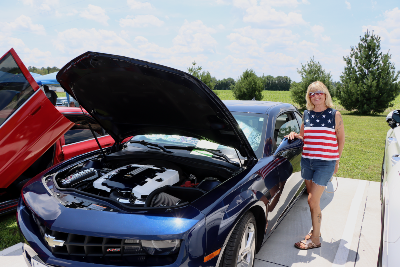 Diana Wheeler stands next to her immaculate 2011 Chevy Camaro, which was part of the car show sponsored by the Lowered Habits Car Club.